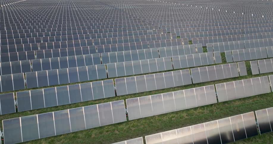 Endless rows of solar panels stretch across an enterprise scale power installation