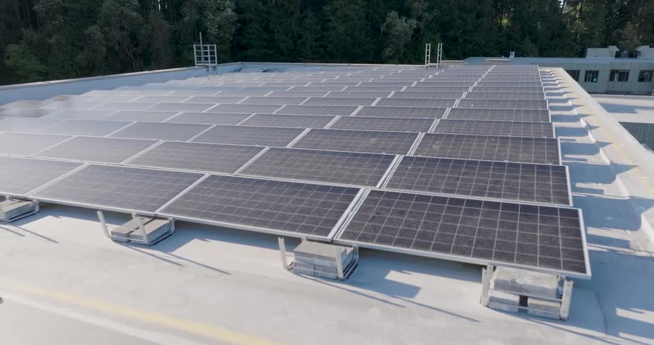 Pullback reveal of a rooftop solar power install on a modern office building