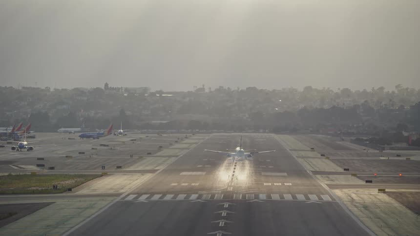 Plane landing on a long airport runway