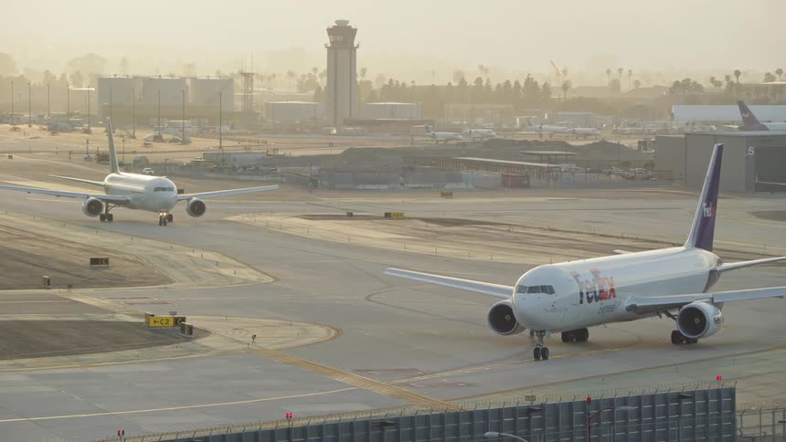 Two planes on an airport runway