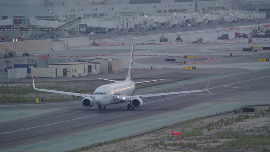 Airplane moving slowly down an airport runway