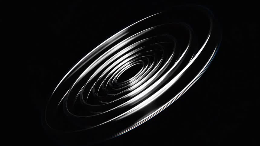 The video displays a dynamically animated abstract object composed of twisting and coiling metallic ribbons against a black background the ribbons reflect light creating a sense of movement and depth as they intertwine