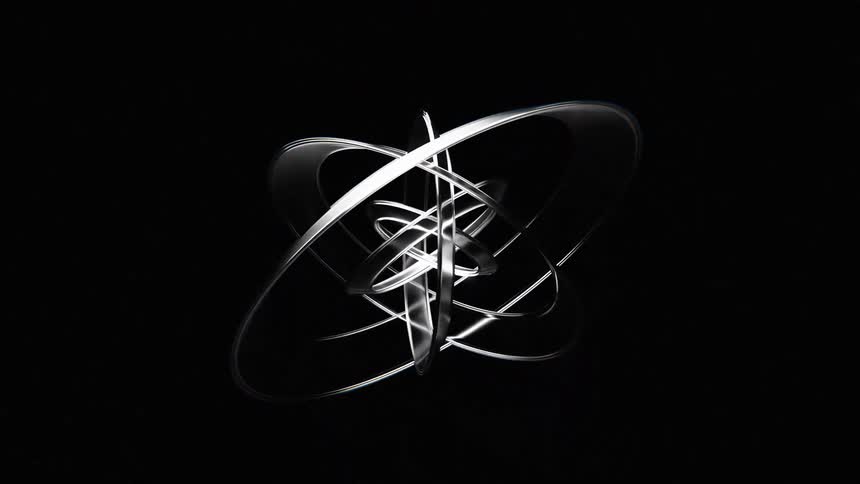 Series of slightly warped clear and reflective rings rotate about a shared center