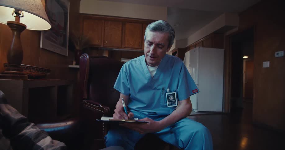 A doctor is talking with a patient at home