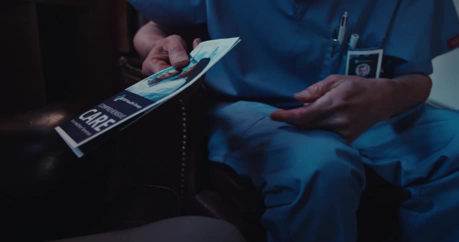 A nurse handed a flyer to a patient in the hospital