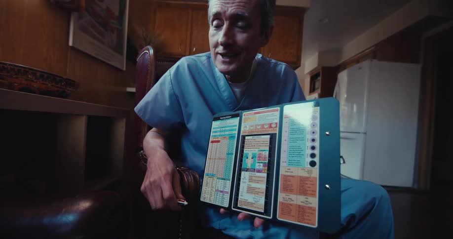 Doctor with a book presenting information to an elderly gentleman