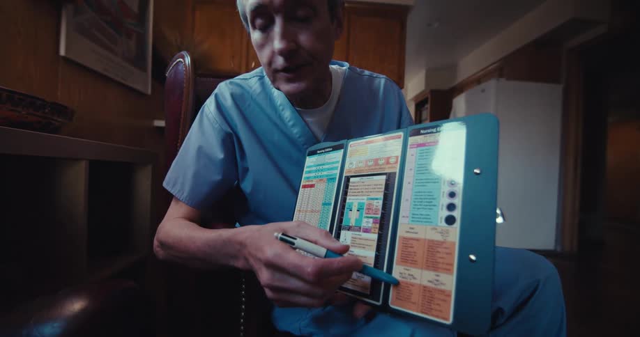 Doctor sitting and talking and presenting a document in an open folder