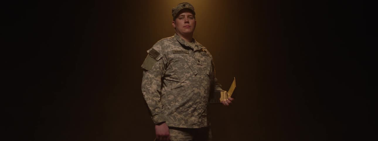 The soldier is holding a box of medals