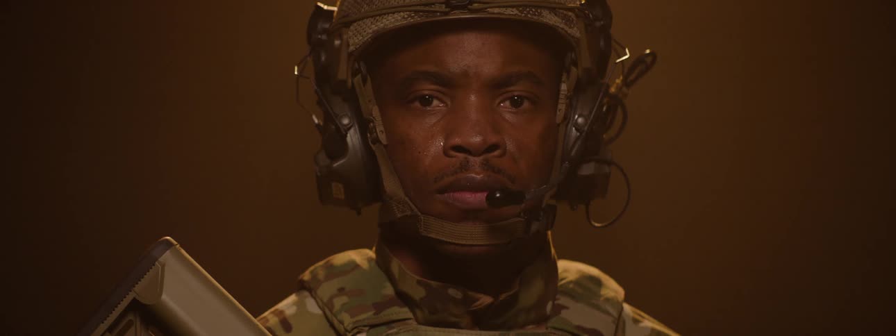 Portrait of a military soldier with a serious expression wearing a helmet