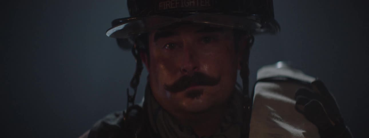 Portrait of a firefighter with a mustache and a sweaty face