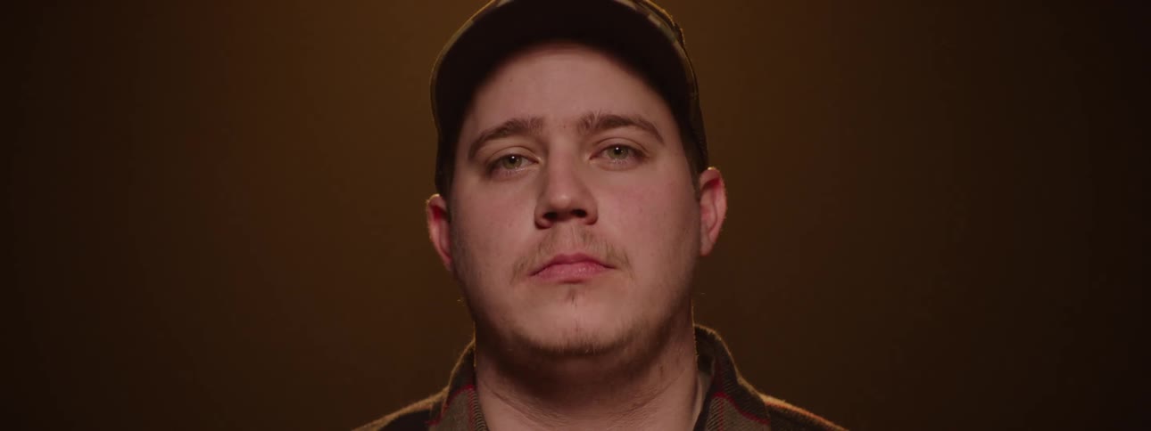 Portrait of a man wearing a cap in a studiolit space
