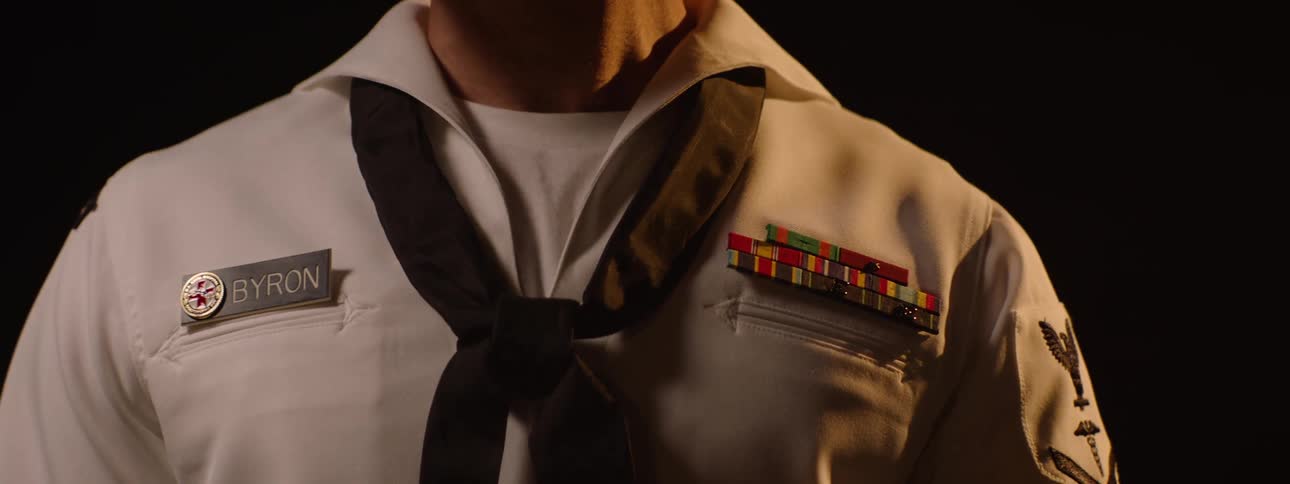 The sailor is wearing his uniform