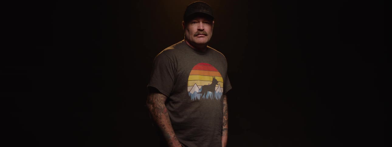 Man with cap and mustache in an indoor space