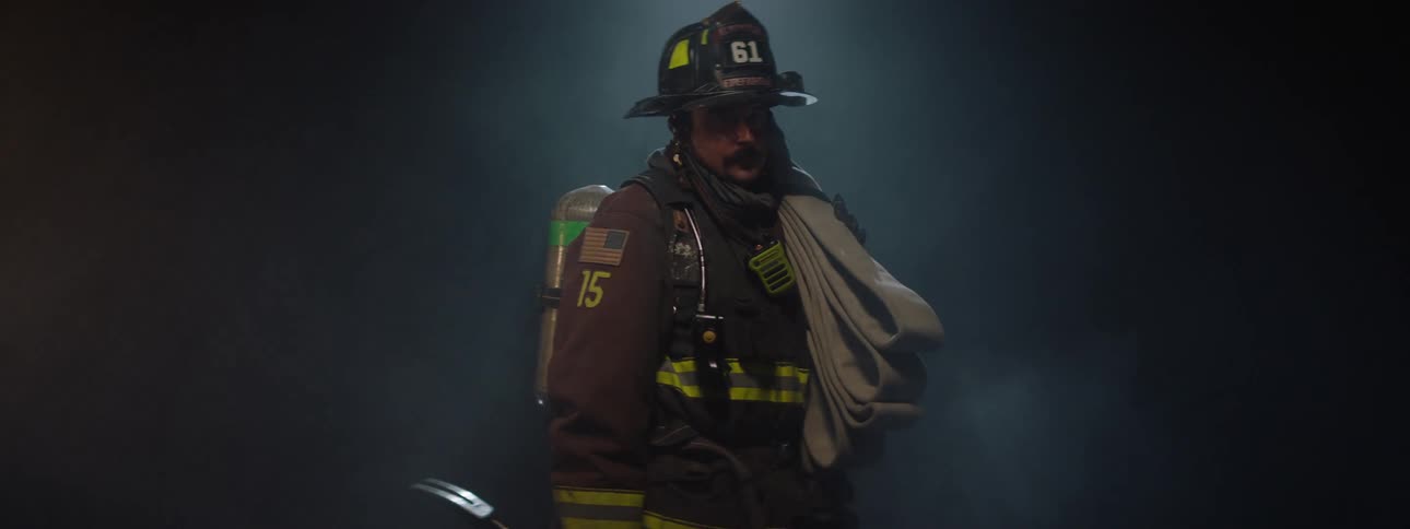 Lights are flashing on the firefighter in the smoke