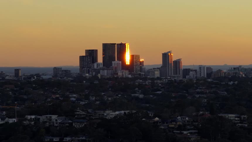Panorama of a metropolis against an orange martinal sky
