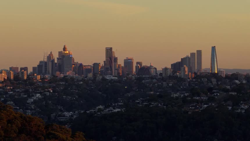The skyline of a city is shown in the distance