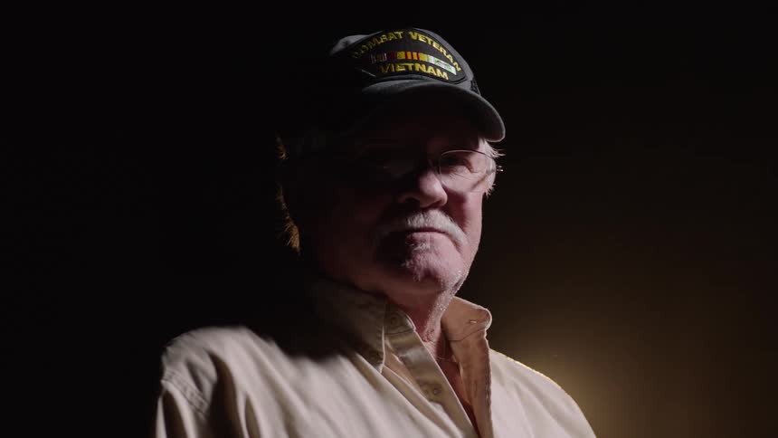 Portrait of an elderly man wearing a cap and glasses