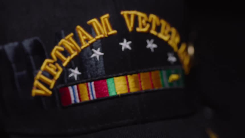 Close up of a vietnam military badge on black face cap placed on a surface