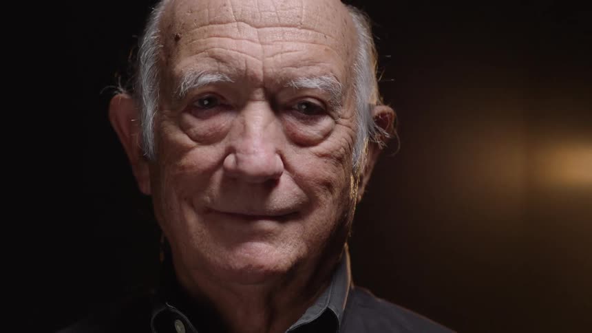 Portrait of a whitehaired elderly man with a happy expression