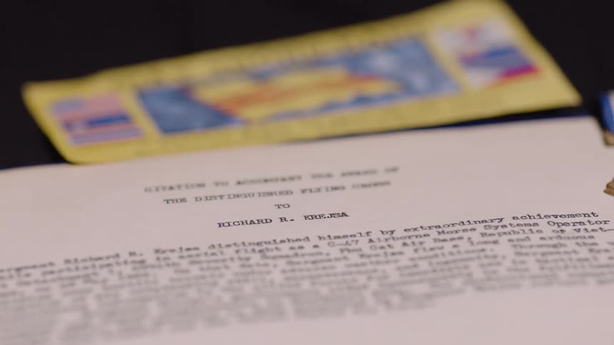 Close up of a white paper with writing of a document and a golden note above