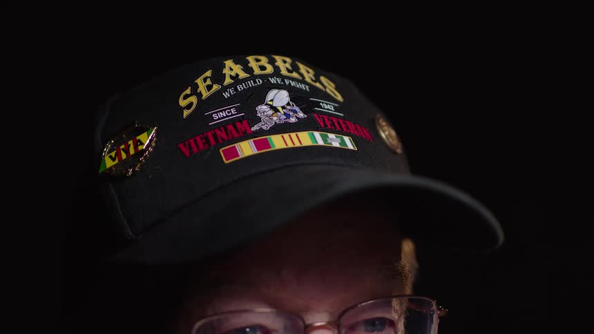 Elderly man with glasses and a cap with a white mustache