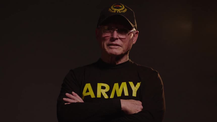 Man in cap and glasses with arms crossed