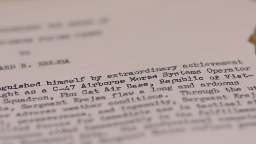 A military medal is on a piece of paper