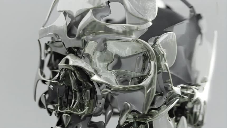 A shiny abstract metallic sculpture twists in a closeup shot