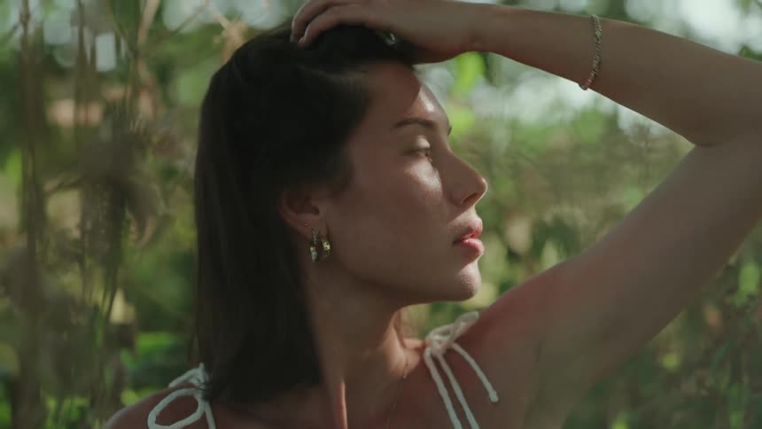 Portrait of a young woman amidst tree vegetation