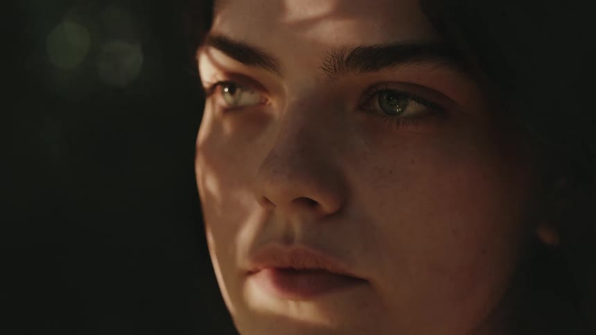 Close up portrait of a young woman standing outdoors during daytime