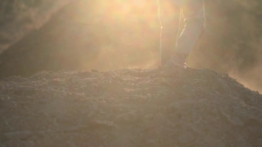 A person kicking dirt