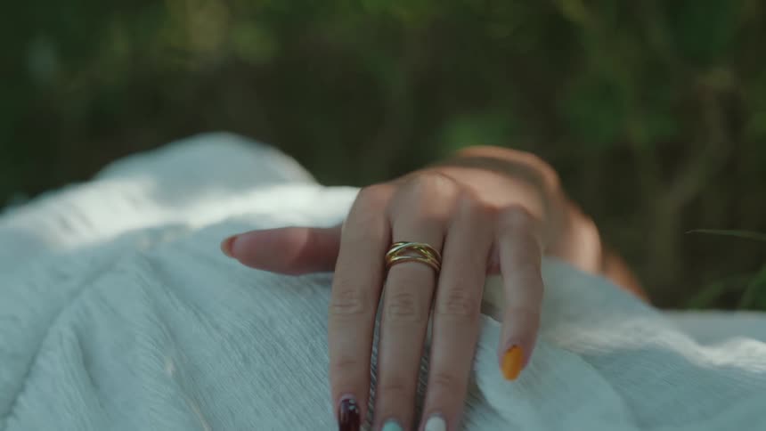 The woman has different color nail polish on each finger