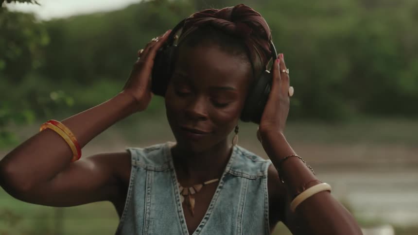 A woman is listening to music on her headphones