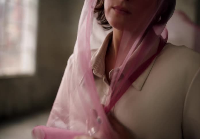 Woman with a pink scarf on her head