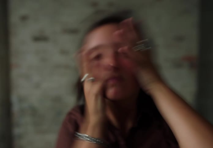 Woman with both hands with rings passing over her face