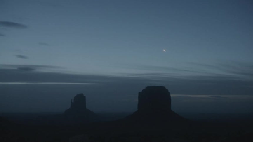 Several rock formations under a darkening sky