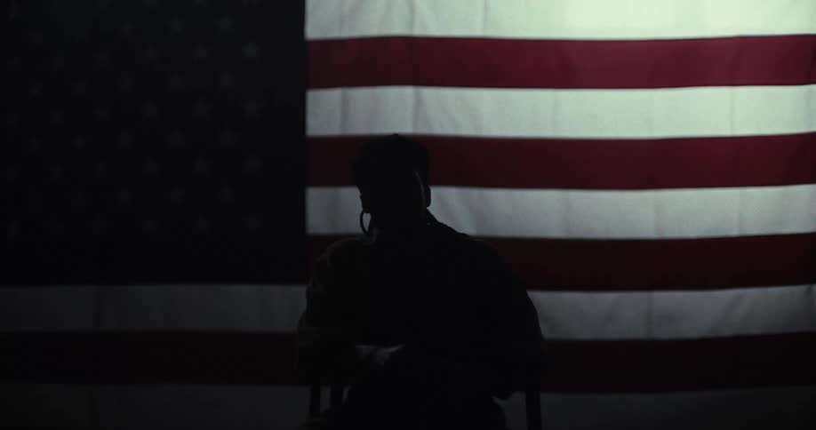 Silhouette of a man sitting on a chair