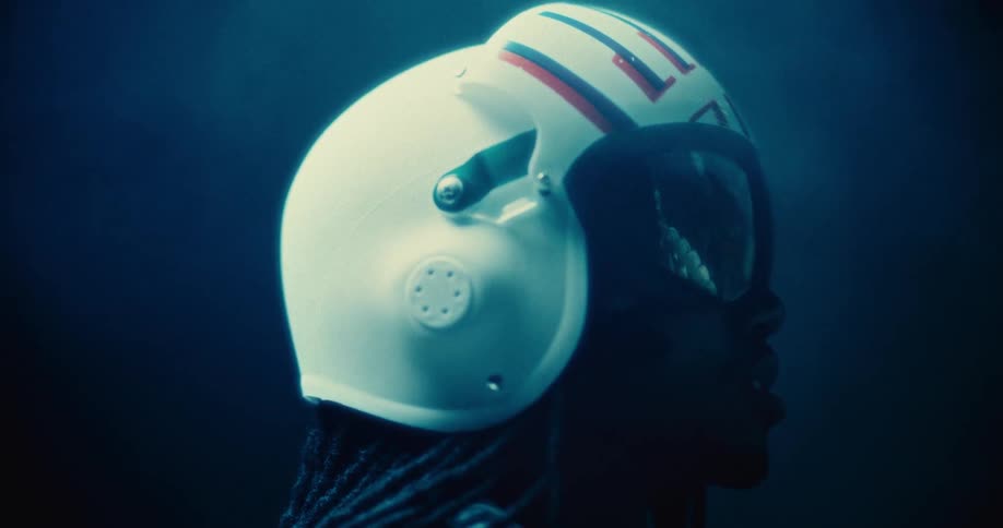 Side portrait of a man in a helmet reflecting an image