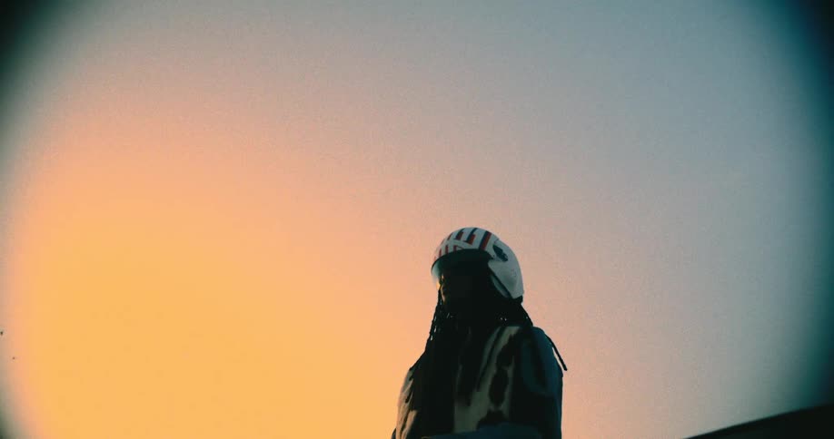 Birds fly over the person wearing a helmet