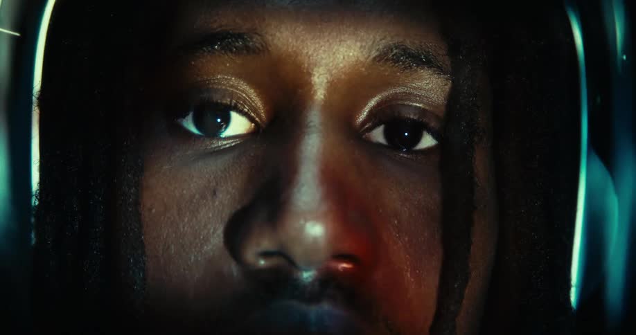 The video presents a tight closeup of a persons face primarily focusing on their eyes and the area around them the eyes are wide and there are subtle reflections of what appears to be blue light suggesting they might be looking at a screen or monito