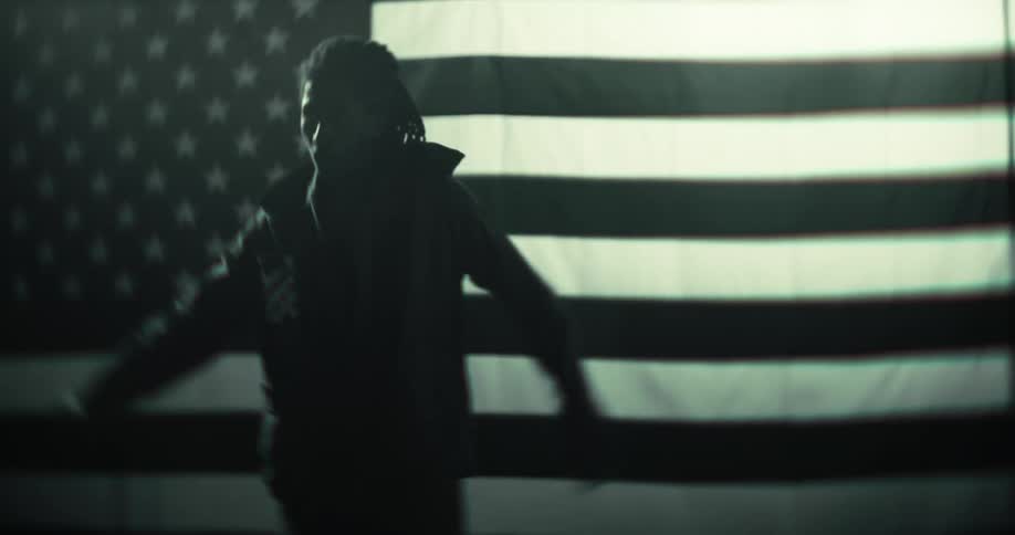 Silhouette of a man indoors opening his arms