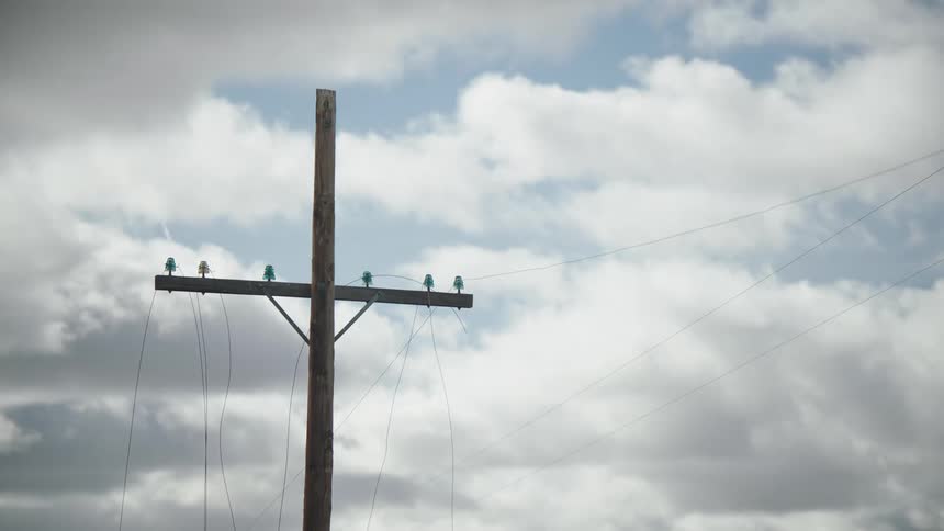 Power transmission pole against a cloudy sky
