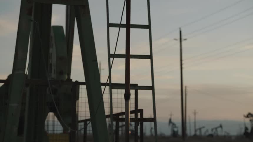 Closeup midshot of the upper part of an oil well pumpjack