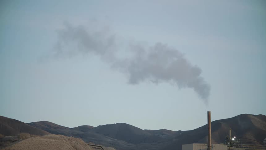Smoke rises from the refinery