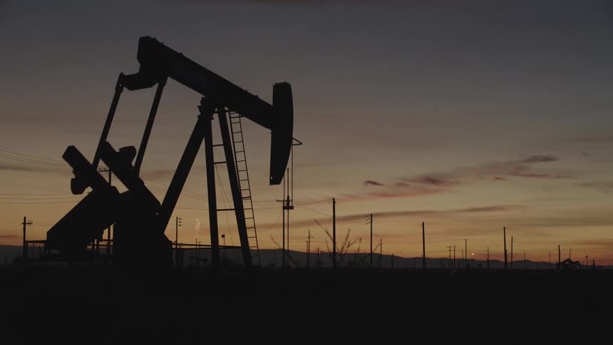 The machinery moves up and down on the oil field