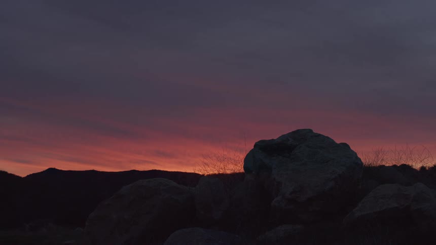 Sunset colors the sky over a rocky area