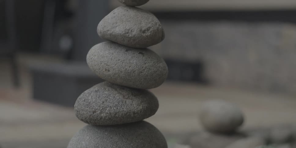 Flowerbed with stones balanced on each other