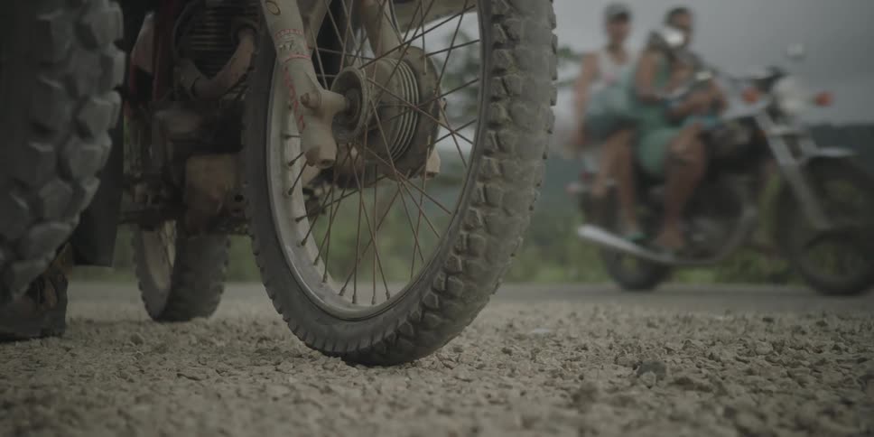 A person speeds off on a dirt bike