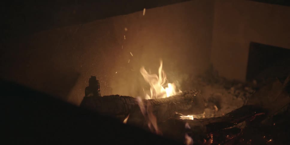 A shovel is used to stir the fire