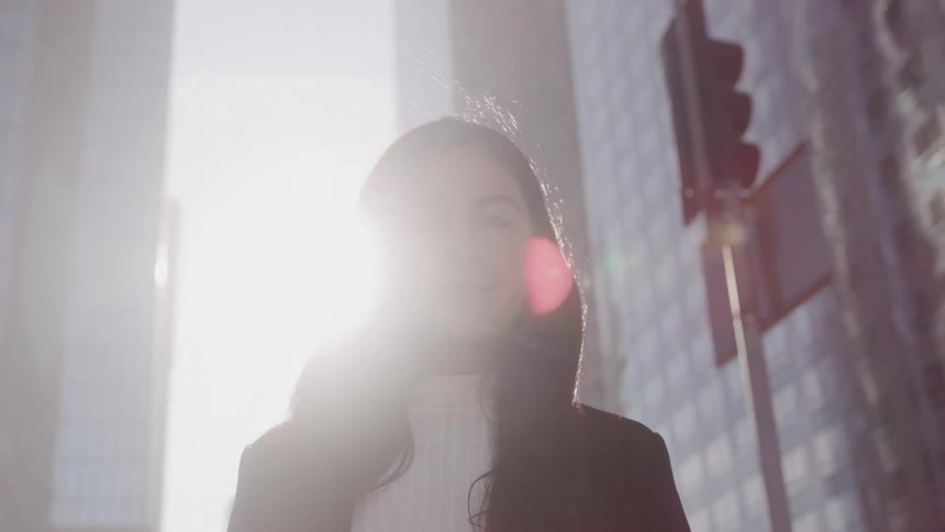 Woman in black blazer outdoors in the city